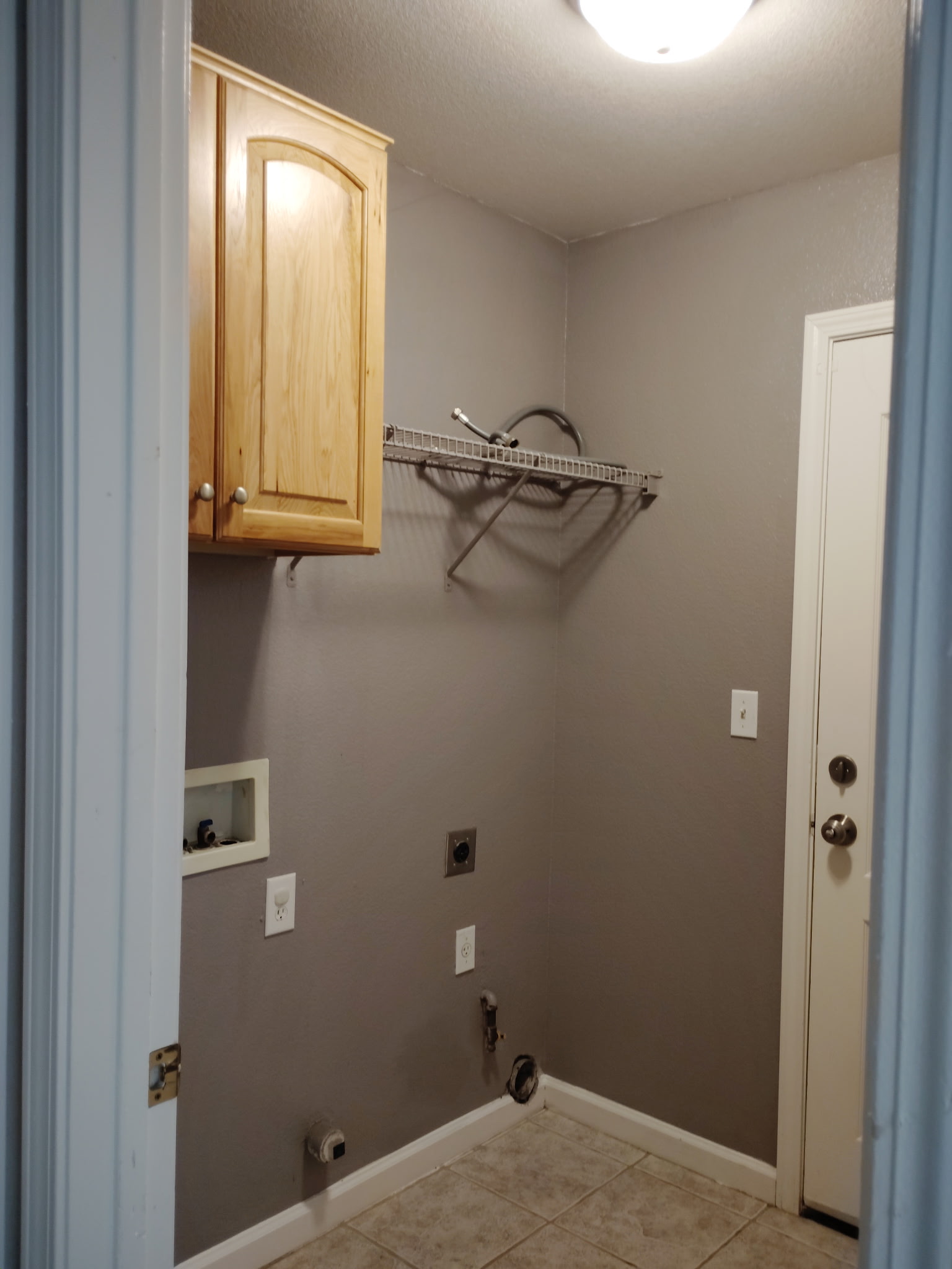 Laundry room with cabinet at 4437 Giselle Lane