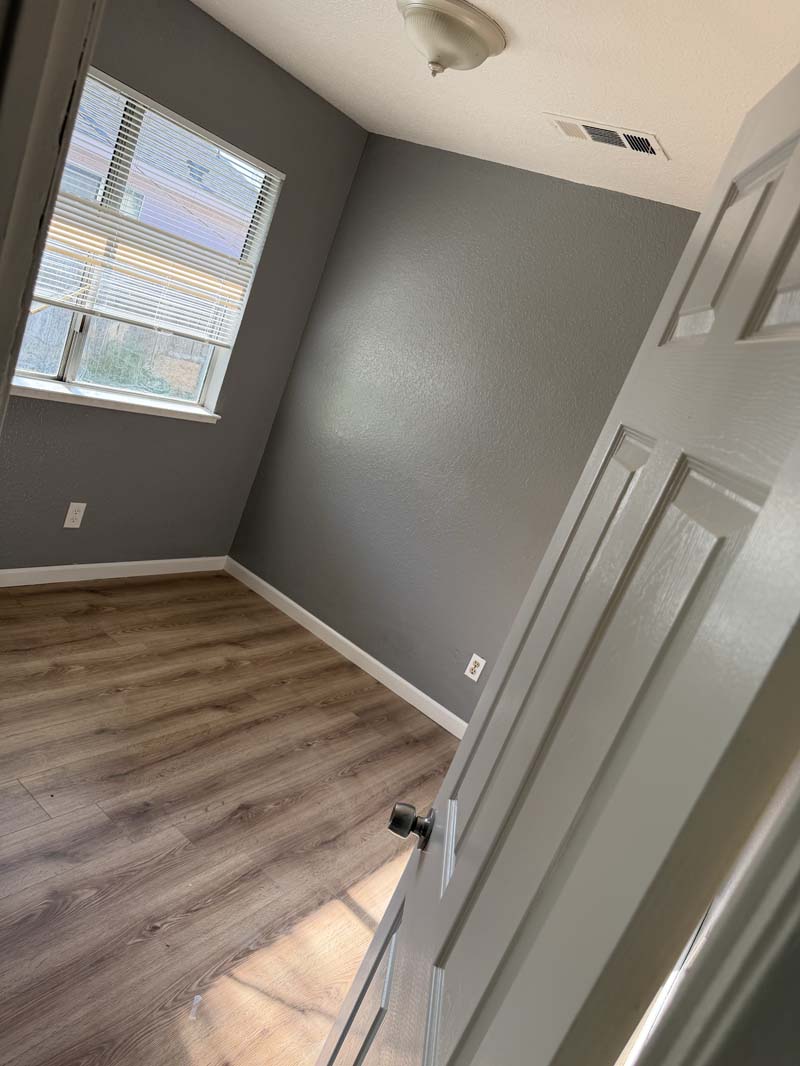 Bedroom with window and wood-look flooring at 674 Gannet Ct