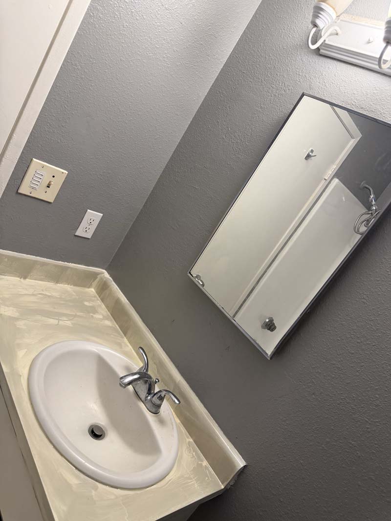 Bathroom vanity with mirrored cabinet at 674 Gannet Ct